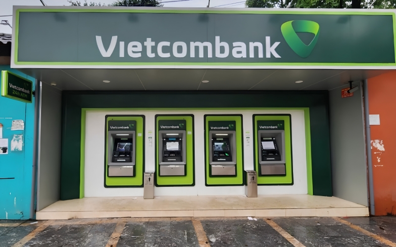 Row of four Vietcombank ATMs outside a bank branch in Vietnam.