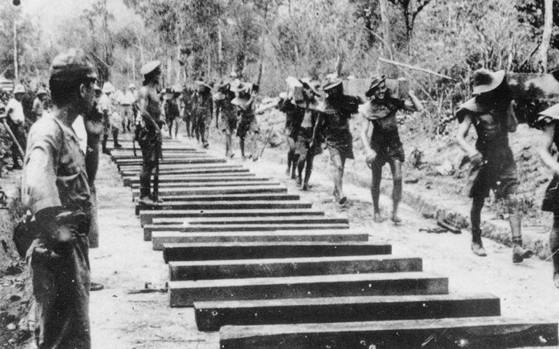 Historical photo of Allied prisoners of war working under harsh conditions to build the Thailand–Burma Death Railway during World War II.