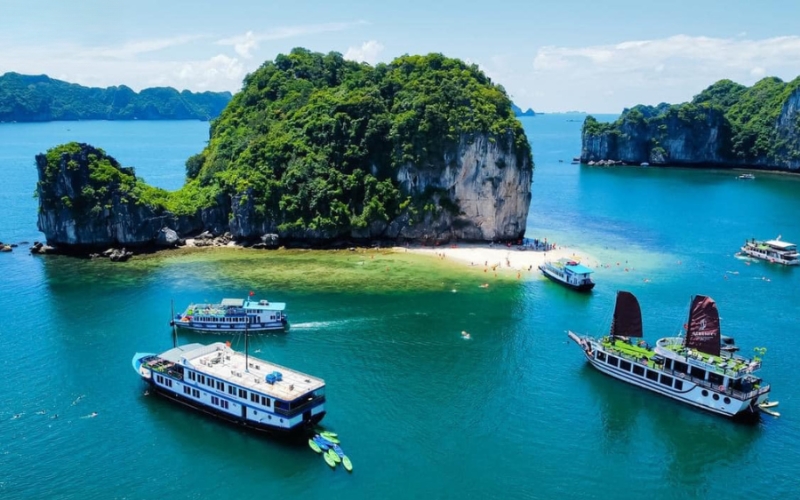 Some cruises glide through the emerald waters of Lan Ha Bay, surrounded by towering limestone karsts and serene seascapes, a must-do experience for visitors to Cat Ba Island.