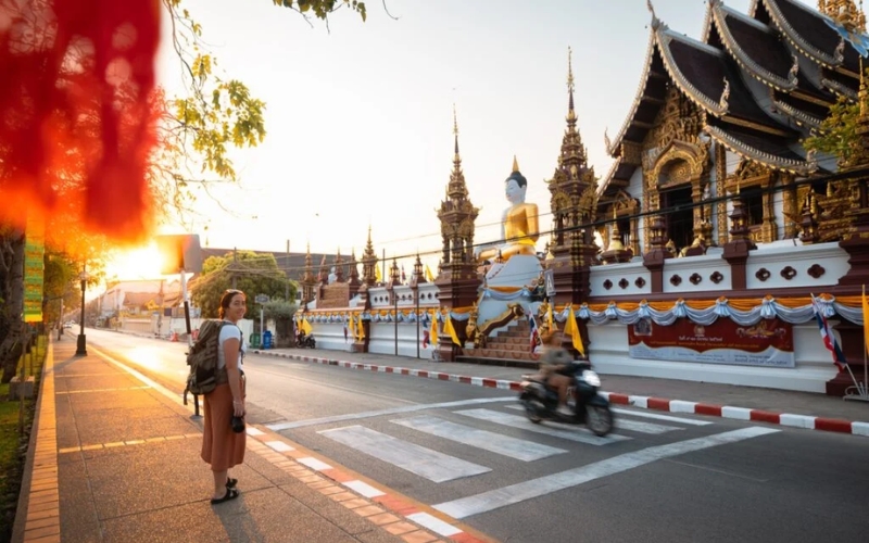 A peaceful street in Chiang Mai’s Old Town, lined with traditional buildings and motorbikes.