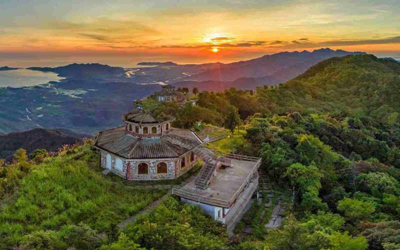 Sunrise view from Hai Vong Dai viewpoint in Bach Ma National Park overlooking mountains, forests, and lagoons in central Vietnam.