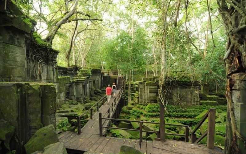 Ruins of Beng Mealea temple with lush greenery surrounding ancient stone structures