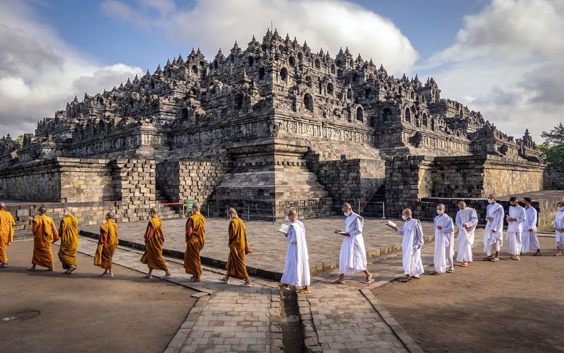 Monks and pilgrims walking near Borobudur Temple in Indonesia, the world's largest Buddhist monument