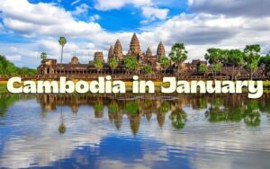 A panoramic view of the majestic Angkor Wat temple complex in Siem Reap, Cambodia, reflected perfectly in a foreground body of water under a partly cloudy blue sky, with the large text "Cambodia in January" overlaid.
