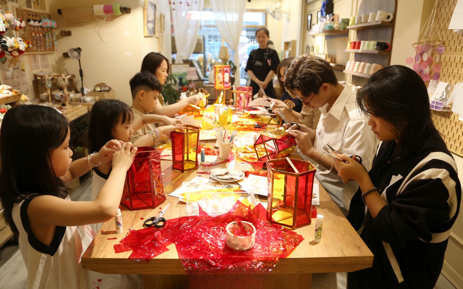 Vietnamese children happily crafting colorful lanterns during the Mid-autumn Festival, a beloved tradition across the country.