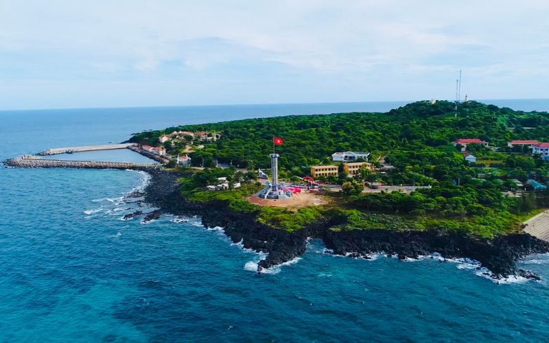Aerial view of Con Co Island, Quang Tri, Vietnam, with lush greenery, lighthouse, and surrounding blue ocean