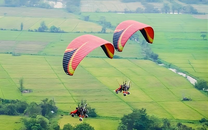 Powered paragliding flight above mountains and valleys near Chiang Mai, northern Thailand.