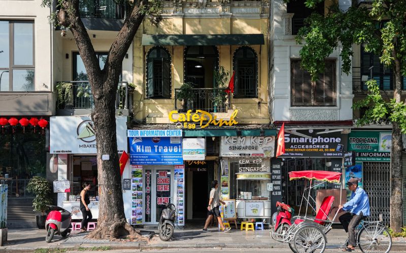 Exterior view of Đinh Café in Hanoi, a vintage coffee shop located on the second floor of an old building overlooking Hoan Kiem Lake