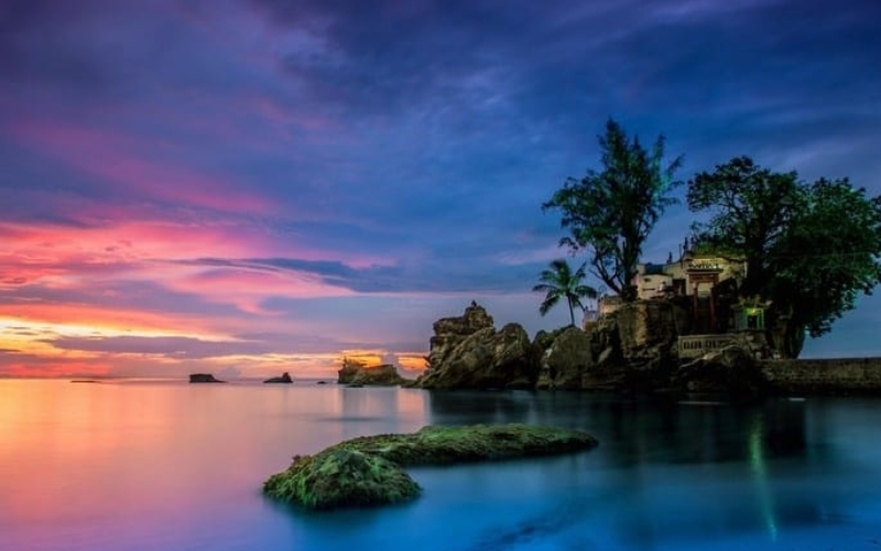 The small temple of Dinh Cau perched on rocky formations at the water’s edge, a cultural and spiritual icon of Phu Quoc Island.