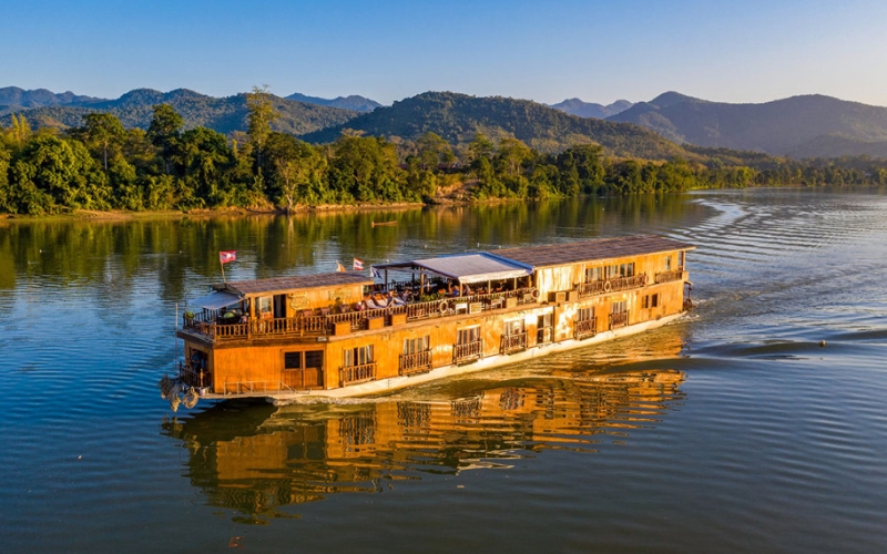 Enjoy the scenic beauty of Laos with a relaxing river cruise on the Mekong