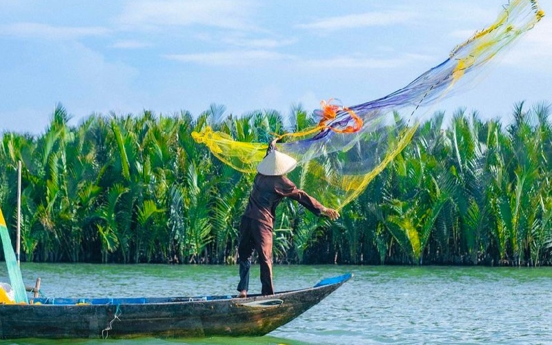 Enjoy a lively performance of traditional fishing net casting in the heart of the coconut forest