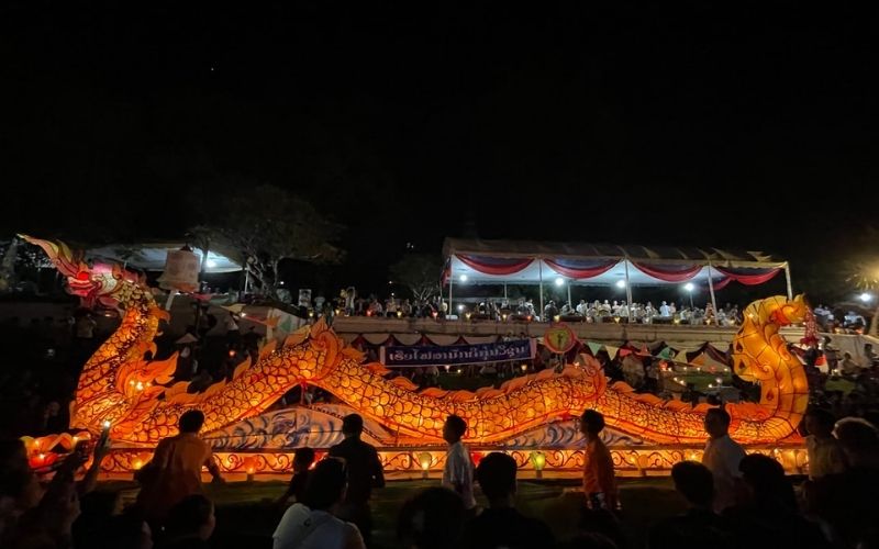 Fire boat procession with a large illuminated dragon-shaped lantern carried through the streets during the Lai Heua Fai Festival in Luang Prabang, Laos.
