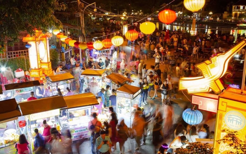 Colorful lanterns light up the Hoi An Night Market, where travelers can stroll along the river, sample local street food, and shop for handmade souvenirs in a lively, festive atmosphere.