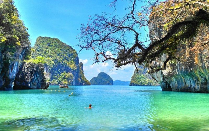 Turquoise lagoon surrounded by limestone cliffs and lush greenery at Hong Island, Krabi, Thailand