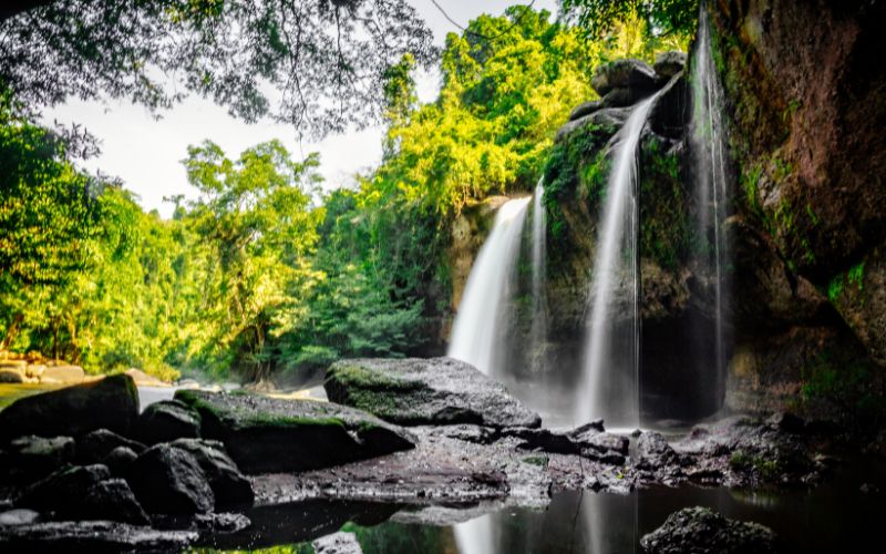 Haew Suwat Waterfall cascading over rocks in Khao Yai National Park surrounded by tropical forest.