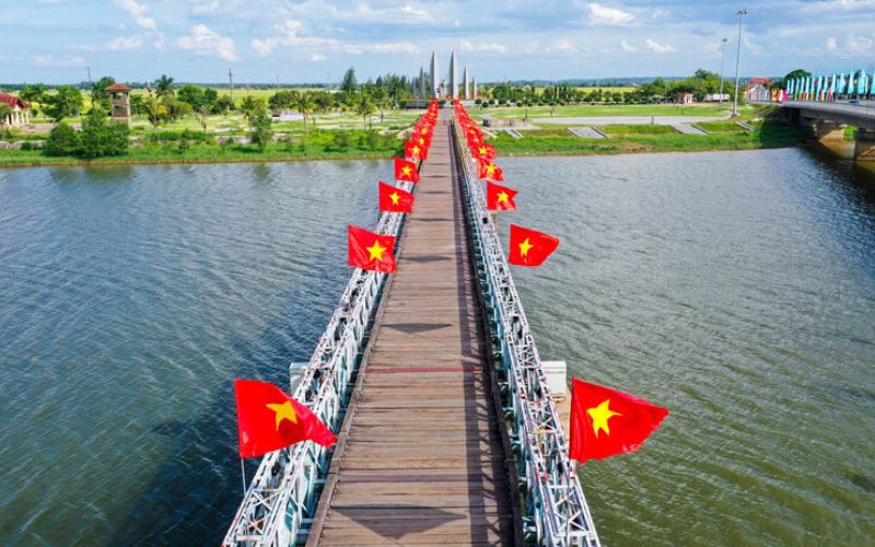 Hien Luong Bridge across Ben Hai River in Quang Tri, Vietnam, decorated with red national flags.