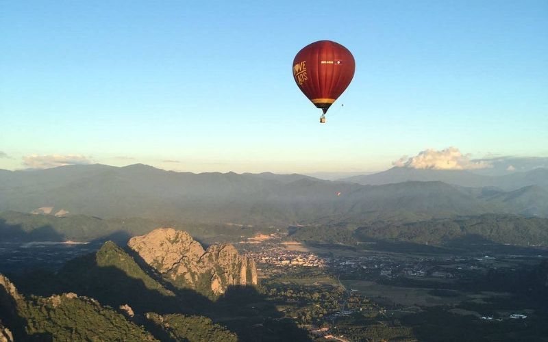Hot air balloon adventure above the limestone mountains and lush valleys of Vang Vieng, Laos