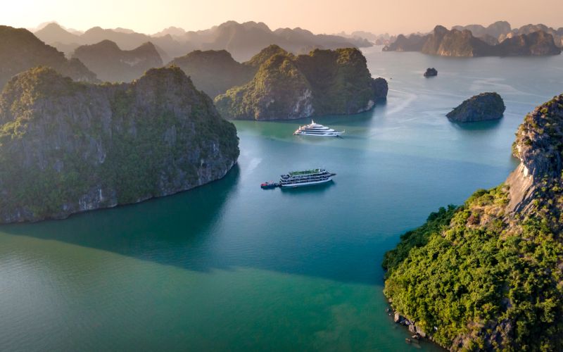 Ha Long Bay in Vietnam with cruise boats sailing among limestone islands in emerald green water