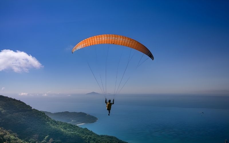 Paragliding flight along the beach in Hua Hin, Thailand.