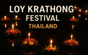 traditional Thai floating lanterns made from banana leaves, flowers, candles, and incense float on the water at night with bright text overlay that reads “Loy Krathong Festival Thailand”