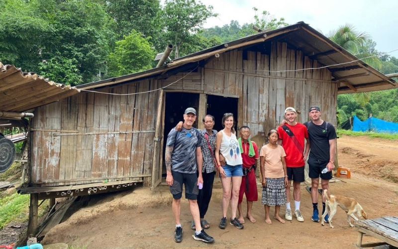 Visitors taking picture with locals at Lahu hill tribe village in Chiang Mai