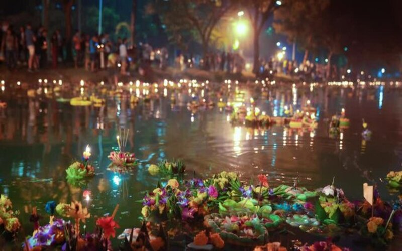 Hundreds of beautifully decorated Krathongs float gently on a river during Thailand’s Loy Krathong Festival