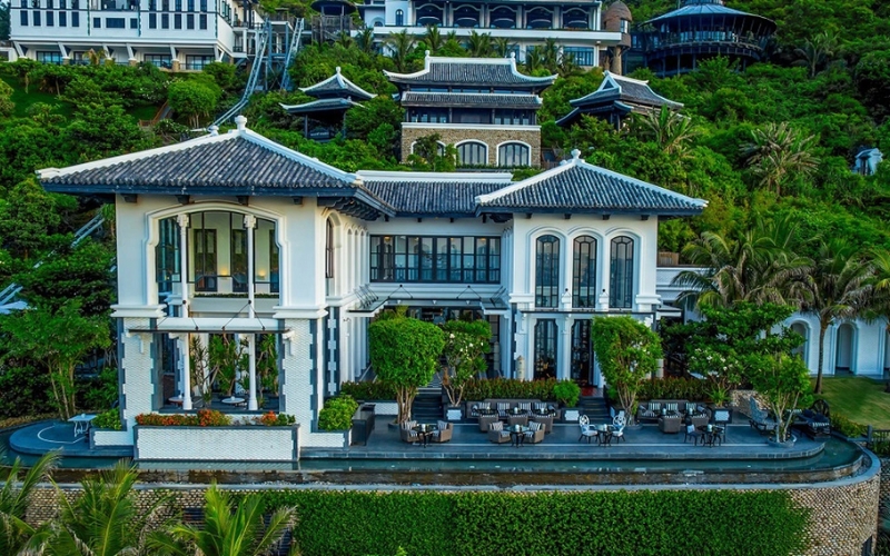 Elegant colonial-style villa of La Maison 1888 nestled in the lush hills of the InterContinental Danang Sun Peninsula Resort, offering Michelin-recognized French fine dining with sea views and timeless charm.