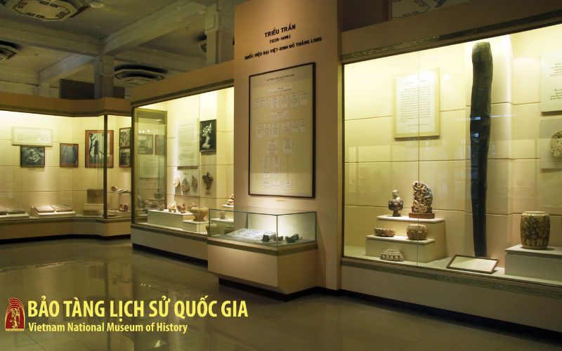 A museum hall showcasing ceramics, statues, and royal artifacts from the Ly, Tran, and Le dynasties of Vietnam.