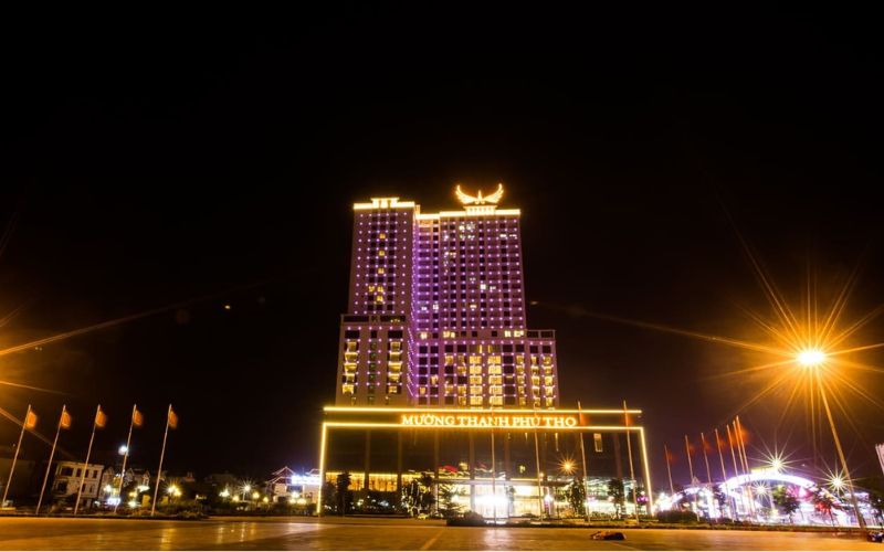 Night view of Muong Thanh Luxury Hotel in Viet Tri, Phu Tho, Vietnam, illuminated with vibrant yellow and purple lights