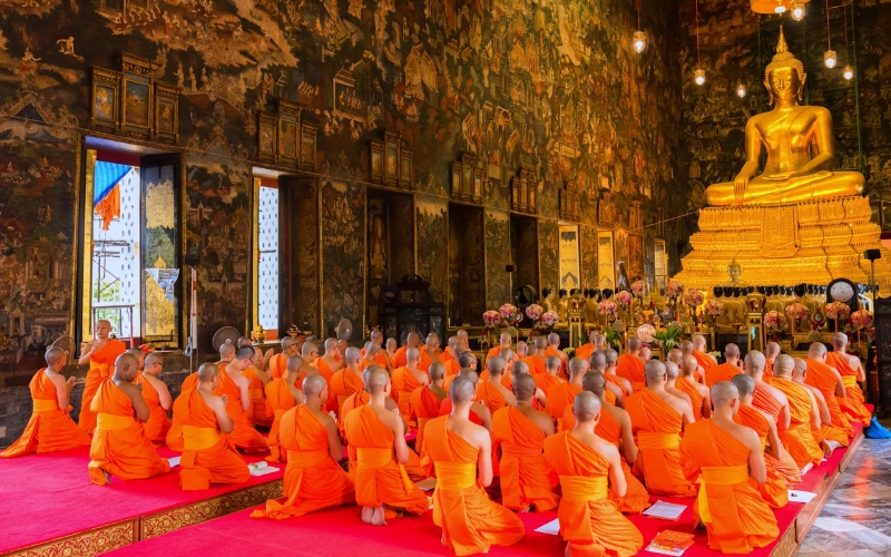 Inside a grand temple hall, Buddhist monks gather in a solemn ceremony marking the start of Khao Phan Sa, or Buddhist Lent, a three-month spiritual retreat during the rainy season.