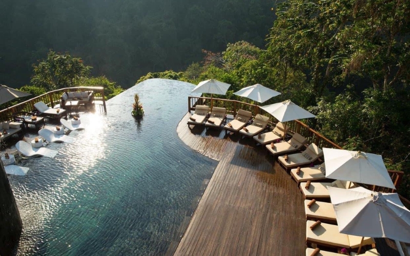 Scenic view of My Lam Mineral Stream in Tuyen Quang, with clear turquoise water surrounded by lush green trees, a peaceful spot known for its hot spring baths and natural relaxation