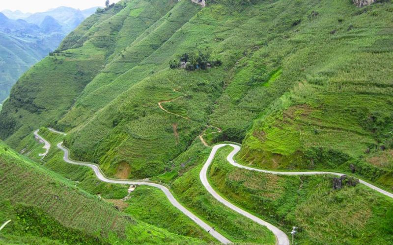 Ma Pi Leng Pass on the Ha Giang Loop, featuring dramatic curves and lush mountain slopes in northern Vietnam