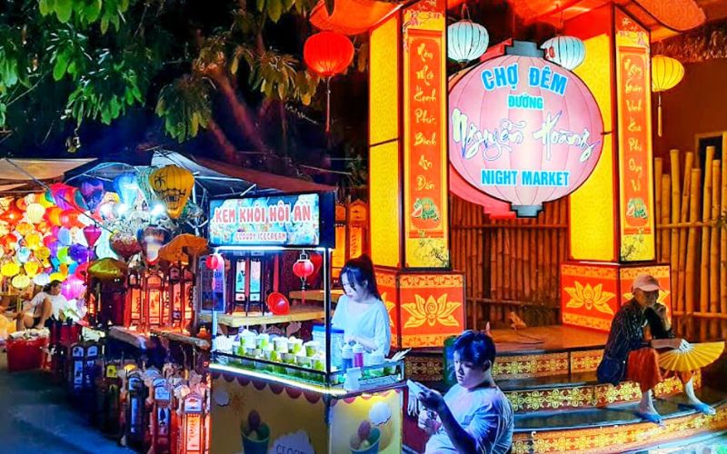 Nguyen Hoang Night Market in Hoi An with colorful lanterns, food stalls, and local souvenirs creating a lively atmosphere