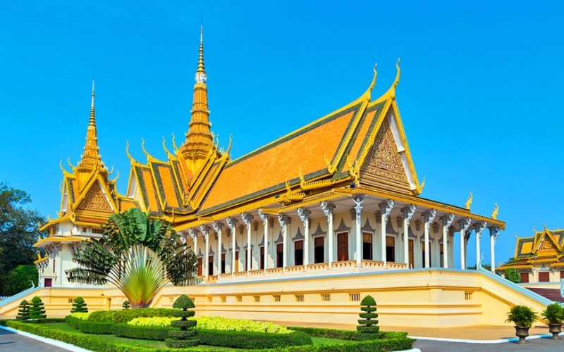 The Royal Palace in Phnom Penh takes on a magical glow during the rainy season, with its golden spires shining against dramatic skies and gardens refreshed by the monsoon rains.