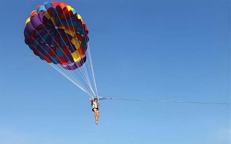 Tandem paragliding flight over coastal landscapes near Pattaya, Thailand.