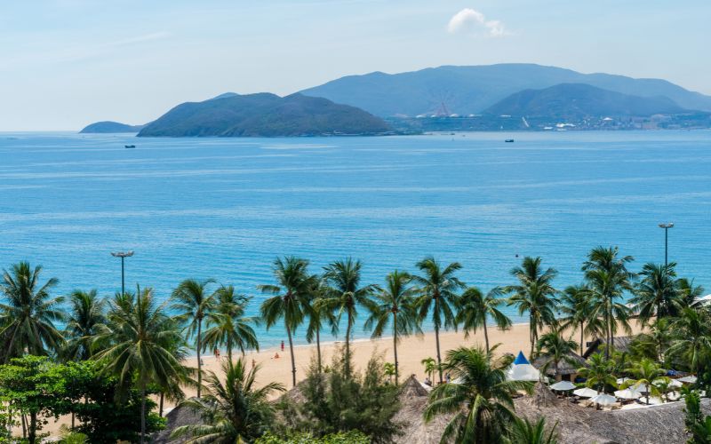 Pristine beach with palm trees and turquoise waters in Nha Trang City, Khanh Hoa, Vietnam
