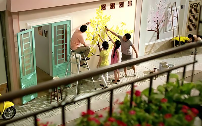 Family repainting their house to prepare for Tet holiday in Vietnam.