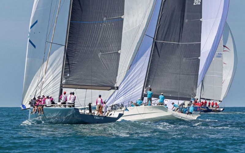 Sailboats competing in the Phuket King’s Cup Regatta in Thailand, with multiple racing yachts and crews navigating the Andaman Sea during one of Asia’s most famous international sailing competitions.