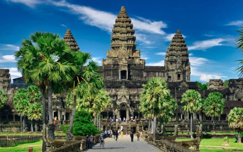 Angkor Wat is especially stunning in the rainy season, surrounded by emerald-green landscapes and moody skies.