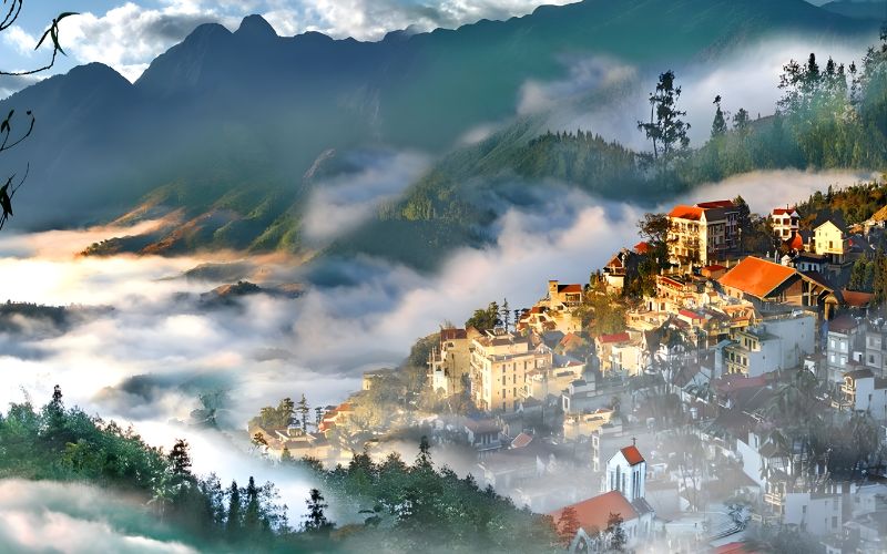 Misty morning view of Sapa town nestled among green mountains and valleys.