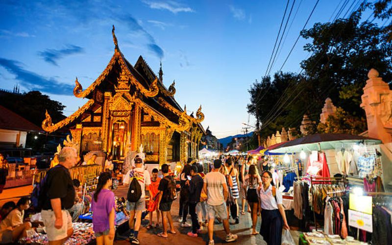The bustling Sunday Walking Street, featuring local street vendors and illuminating Lanna architecture