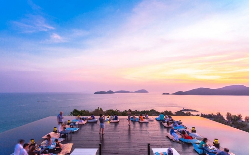 Baba Nest rooftop bar with its infinity deck surrounded by water, offering 360-degree views of the Andaman Sea and Phuket’s islands at sunset.