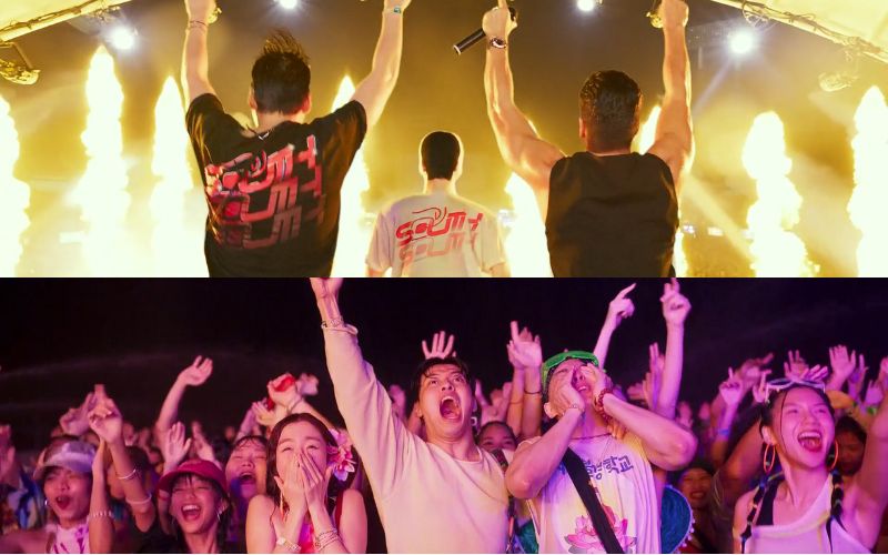 Young travelers celebrating at a lively Songkran music festival in Thailand, surrounded by lights, flames, and cheering crowds.