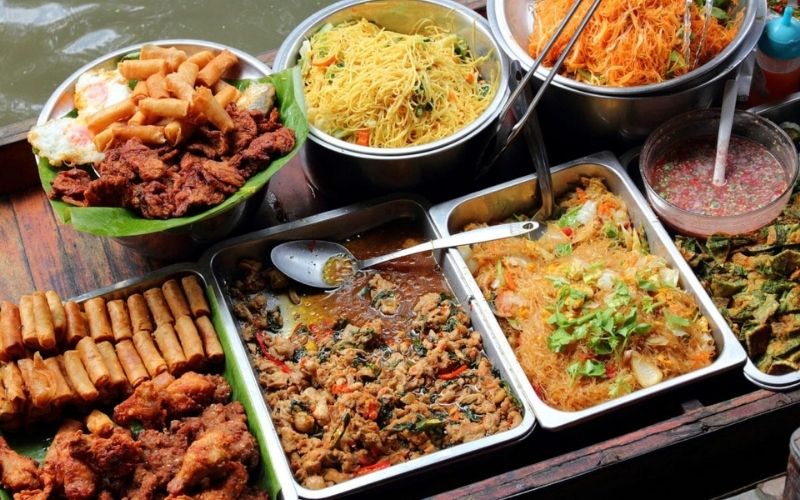 Traditional Thai street food with noodles, fried snacks, and spicy dishes.