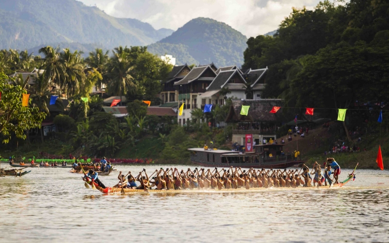 Decorated wooden boats during the annual Khao Phansa boat races in Luang Prabang, held along the Mekong River, symbolizing unity and merit-making at the start of Buddhist Lent.