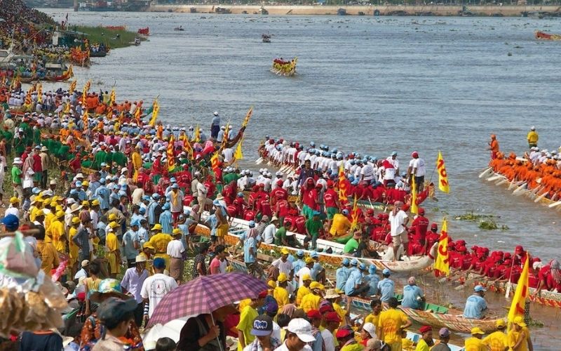 Bustling crowd gathered along the riverside in Phnom Penh watching the vibrant boat races during the Bon Om Touk Water Festival in Cambodia