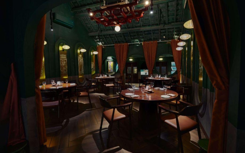 Gia Restaurant’s intimate dining room in Hanoi, designed with minimalist elegance. The space features earthy tones, soft lighting, and curated Vietnamese decor, creating a calm, refined atmosphere that enhances the fine dining experience.