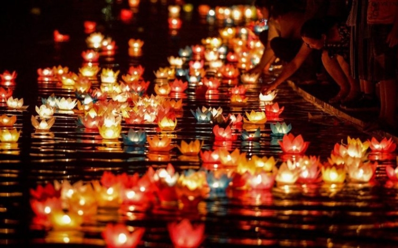 The magical glow of floating lanterns on the Hoai River at night