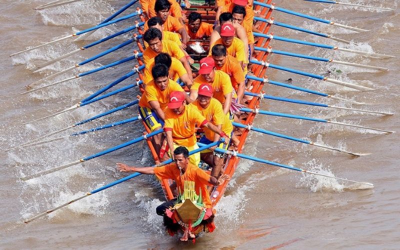 Traditional Cambodian boat team rowing in unison during the Bom Om Touk Water Festival on the river