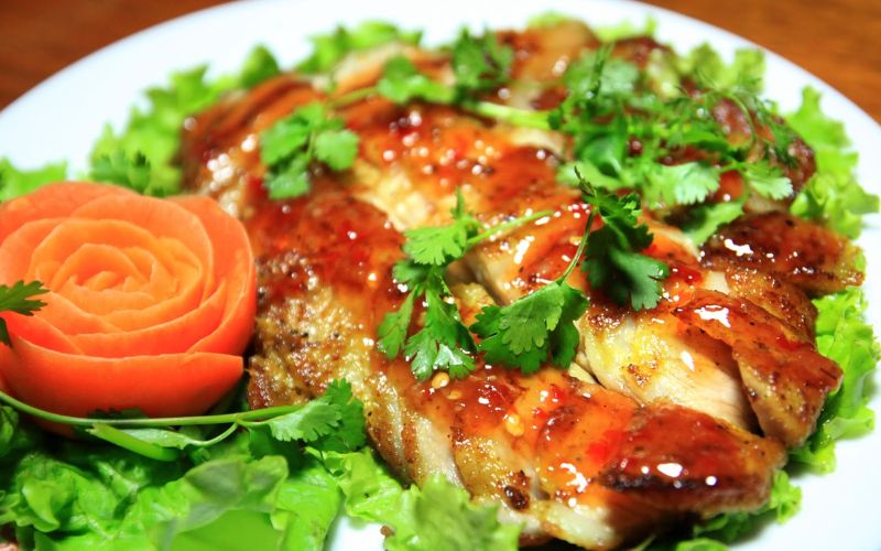Grilled free-range pork from Sapa served with fresh herbs and lettuce, a traditional specialty of northern Vietnam.